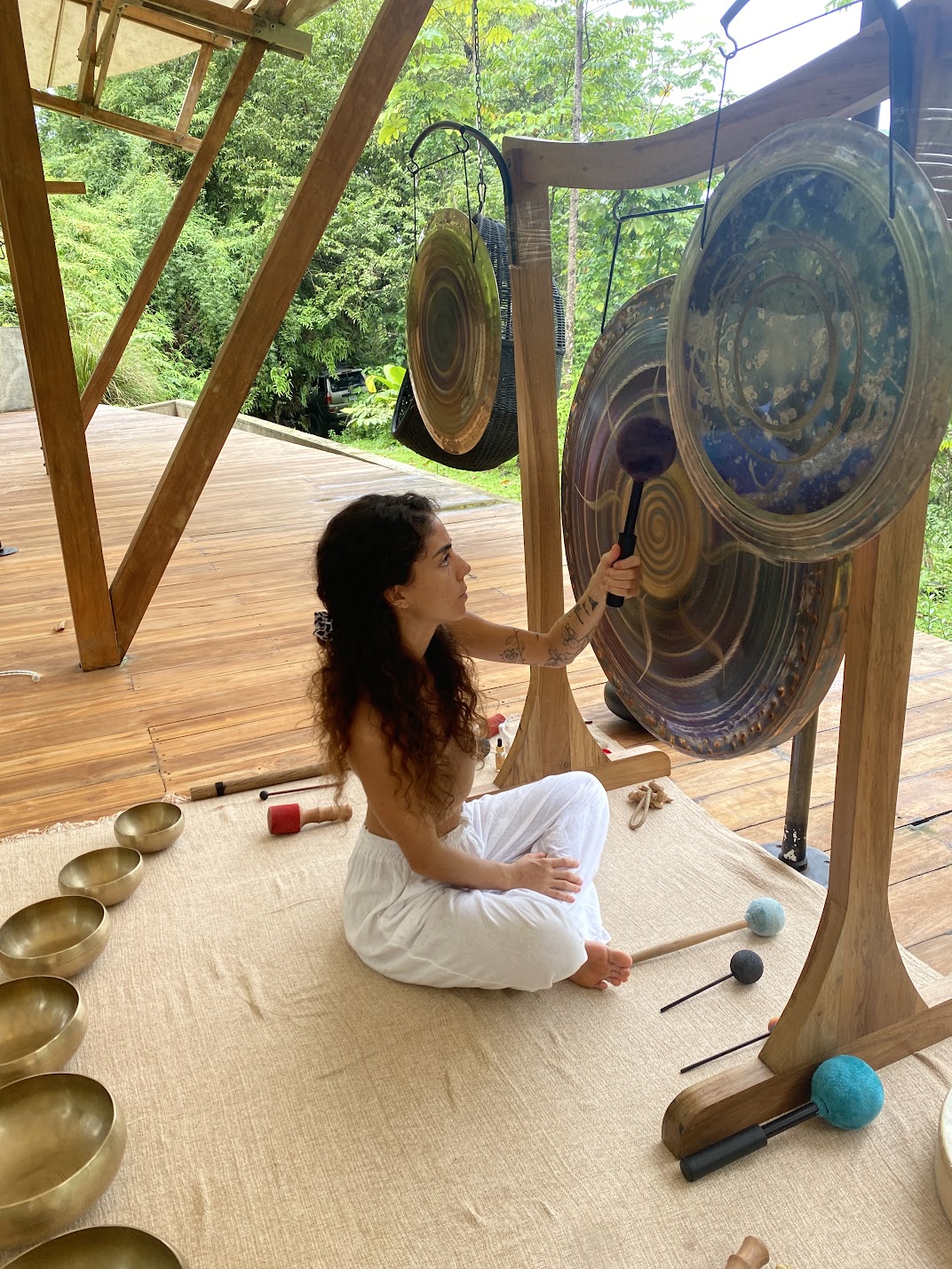 Yoselyn creating a live sound journey with gongs
