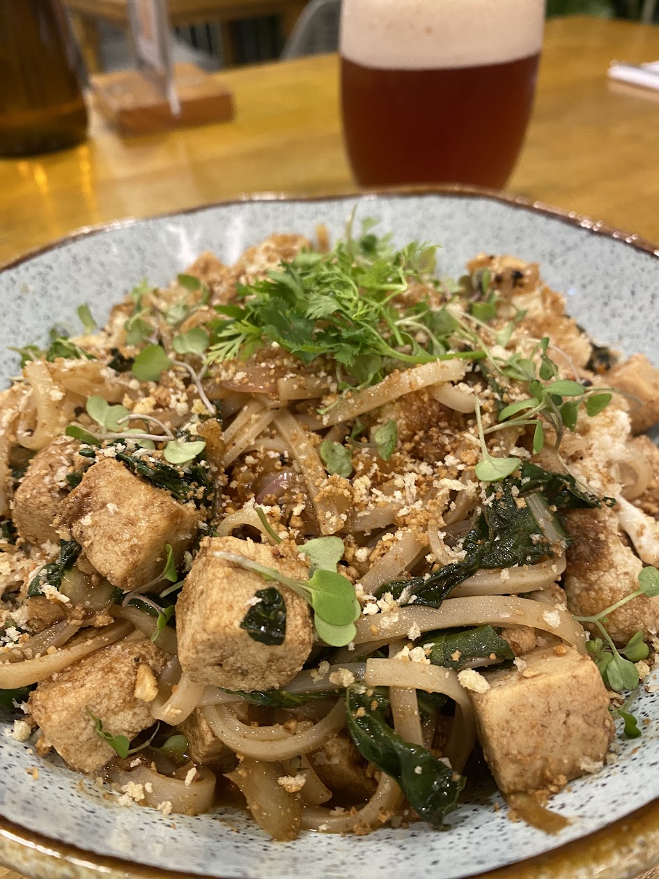 Noodles with tofu, greens, and fresh herbs
